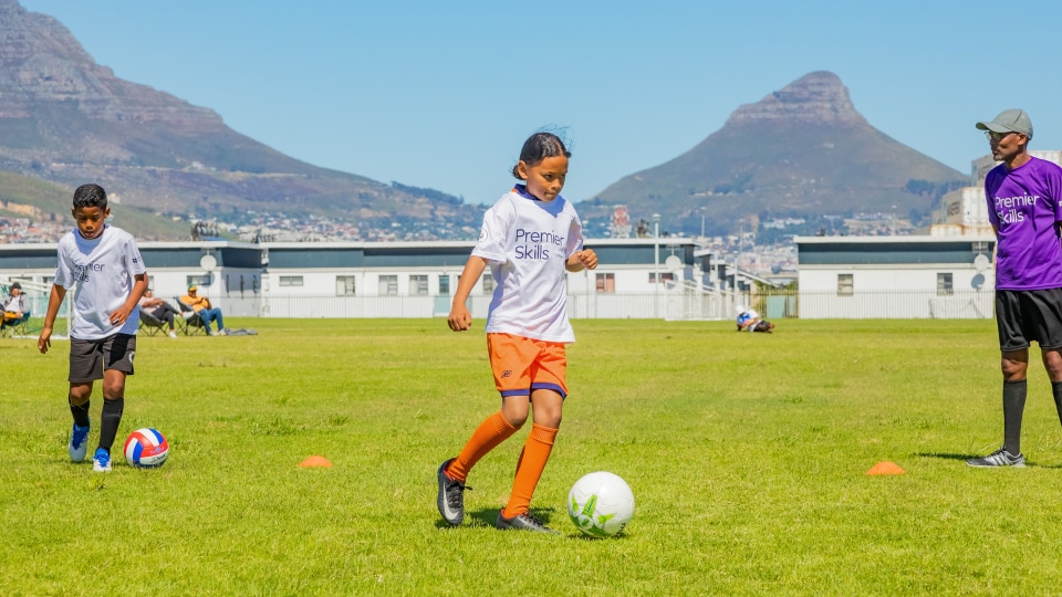 A girl dribbling a ball in a PE lesson