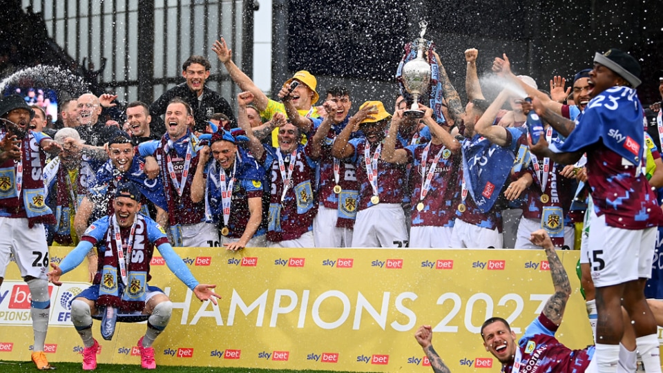 Players of Burnley celebrate with the Championship trophy as they celebrate promotion to the Premier League