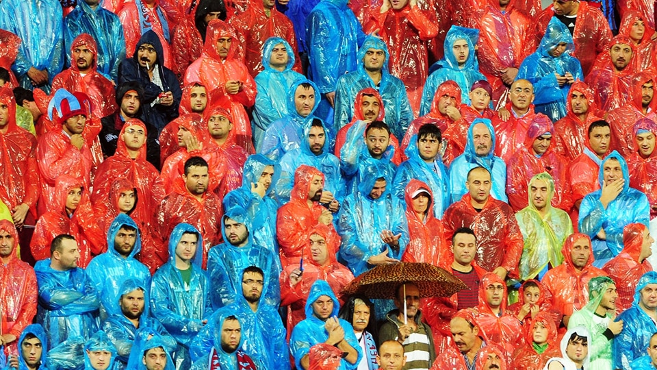 Football fans braving the rain.