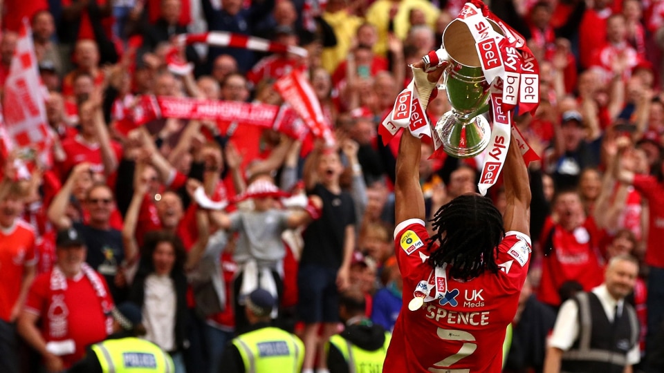 Djed Spence of Nottingham Forest lifts the trophy following their sides victory