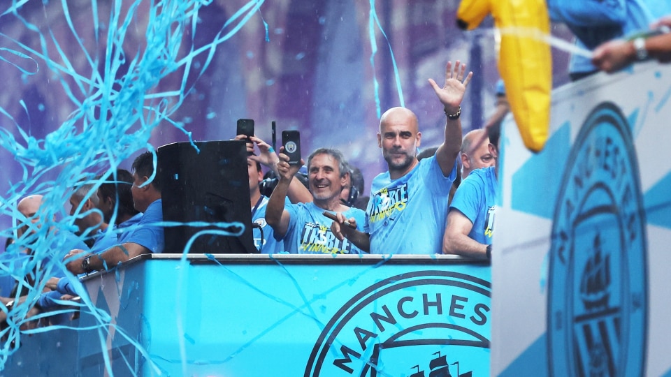 manchestercitymanagerpepgardiolawavesfromthebackofthebusasplayersofmanchestercitycelebrate-Enhanced-SR