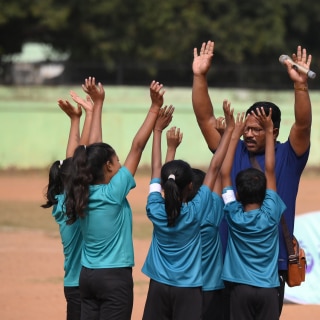 Children and a teacher at a Premier League Primary Stars event in India