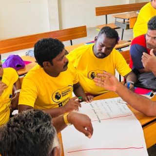 A group of teachers in India in a Premier League Primary Stars training session