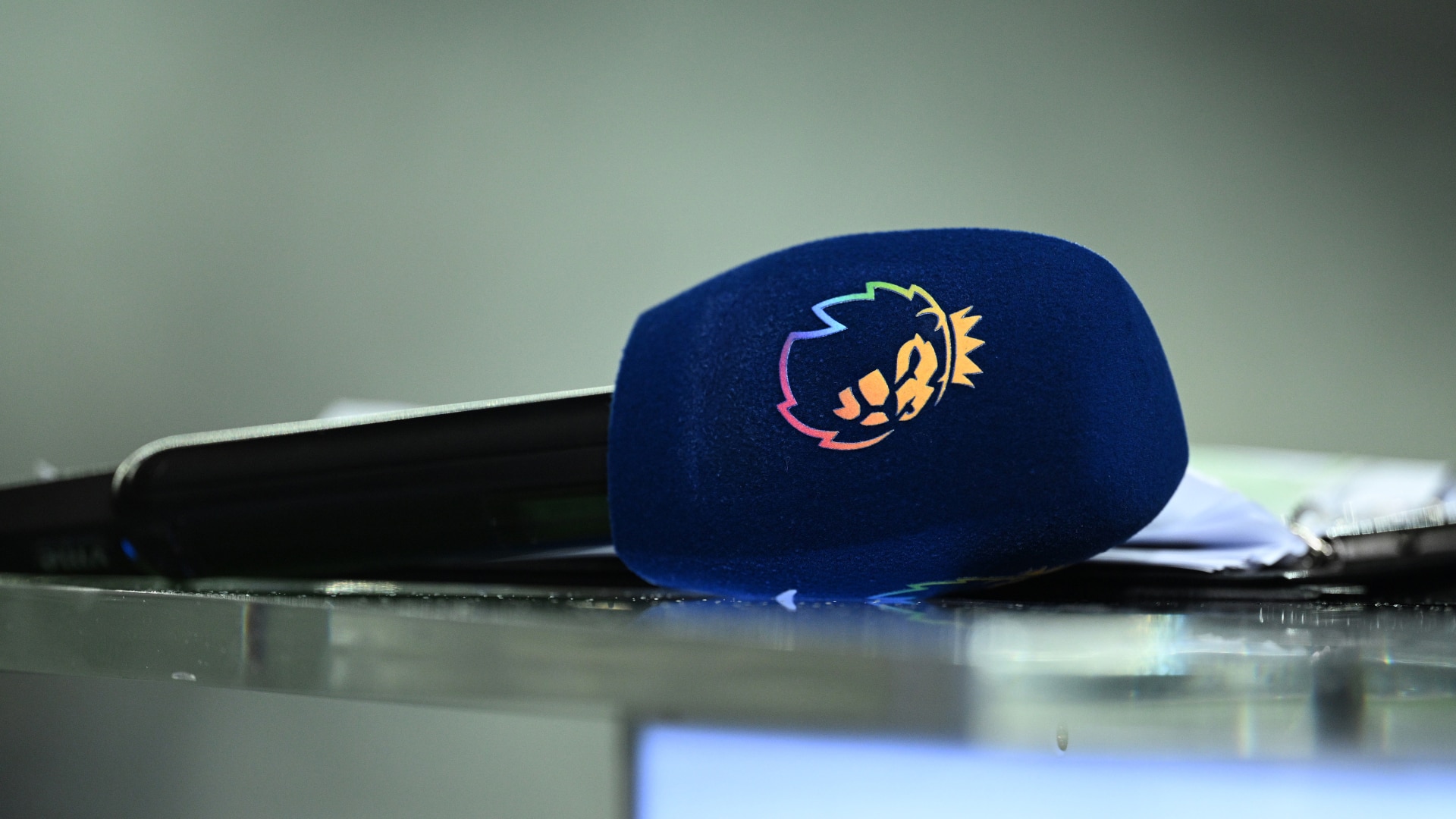 A microphone lies on a desk after an interview