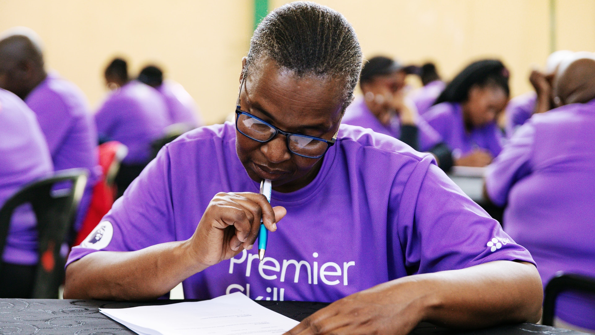 A teacher is concentrating on a task in a Premier Skills session.