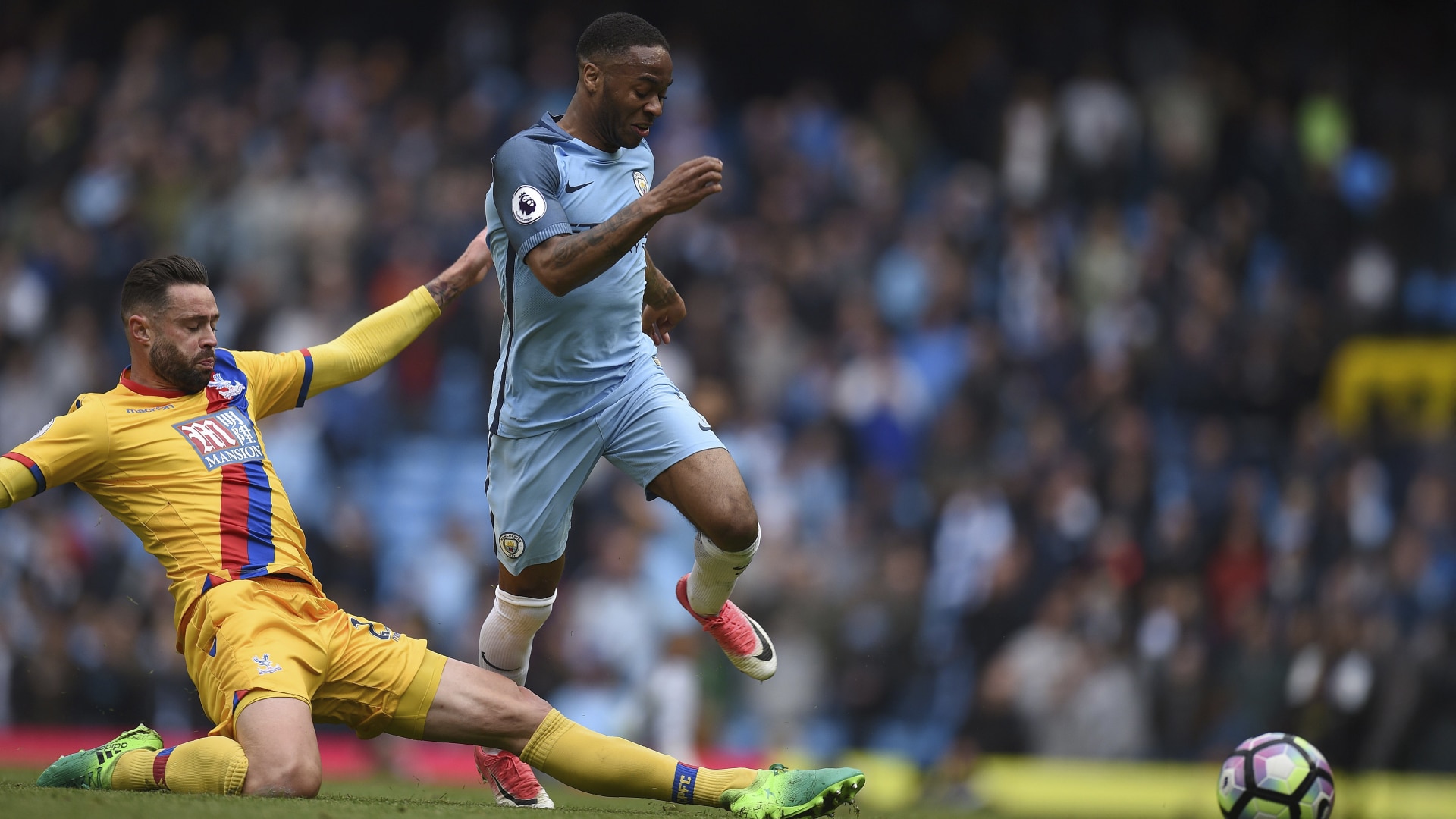 Crystal Palace's Irish defender Damien Delaney (L) fouls Manchester City's English midfielder Raheem Sterling