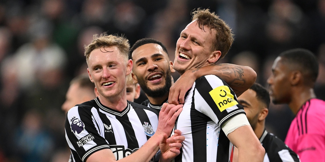 Dan Burn celebrates with teammates Emil Krafth and Callum Wilson after scoring Newcastle United's third goal