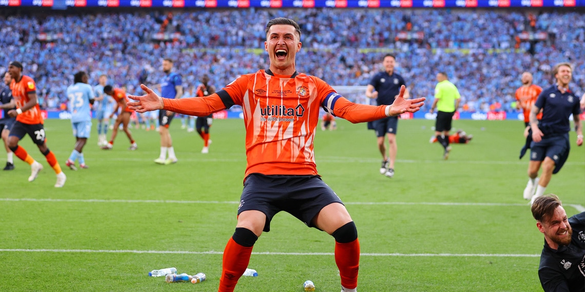 Dan Potts of Luton Town celebrates after Fankaty Dabo of Coventry City misses a penalty