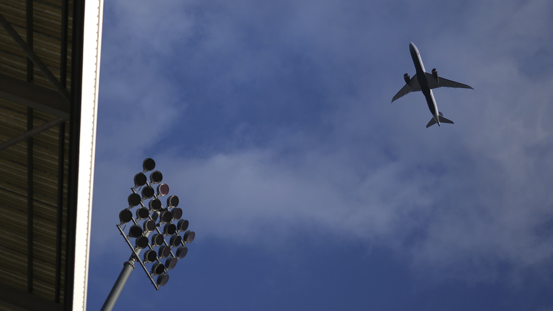 A plane flies over Craven Cottage in London