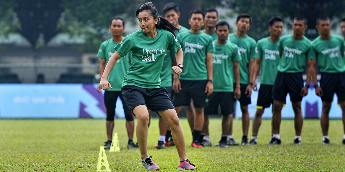 A coach in Indonesia shows her colleagues how it's done.