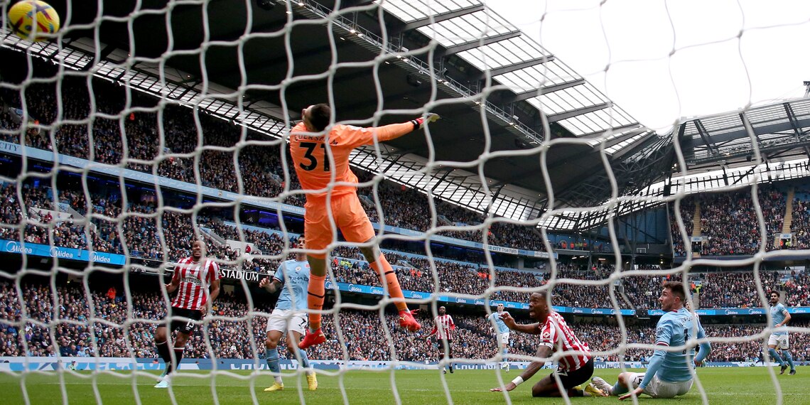 Ivan Toney scores Brentford's first goal past Ederson of Manchester City