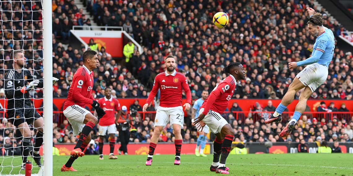 Jack Grealish scores Manchester City's first goal as David De Gea looks on during the Manchester Derby