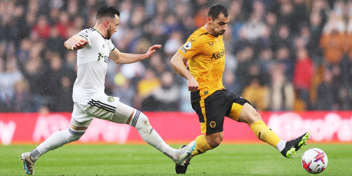 Jonny of Wolverhampton Wanderers passes the ball while under pressure from Jack Harrison of Leeds United