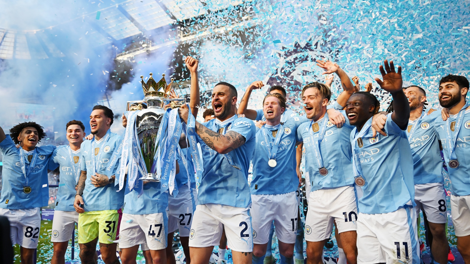 Kyle Walker of Manchester City lifts the Premier League Trophy after their team's victory