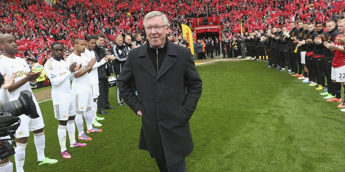 Manager Sir Alex Ferguson of Manchester United is given a guard of honour by both teams