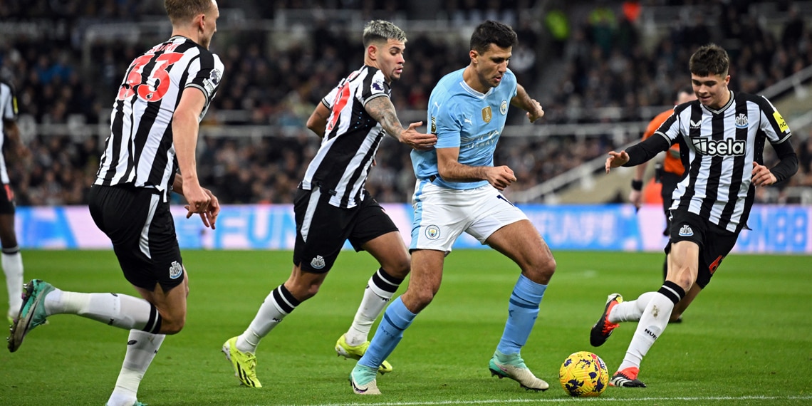 Manchester City's Rodri vies with Newcastle United's Dan Burn, Bruno Guimaraes and Lewis Miley