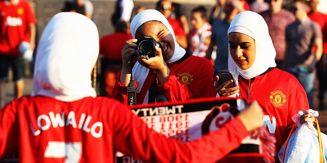 Manchester United fans before a match at Old Trafford. Are you a Man Utd fan? Why do you support them?