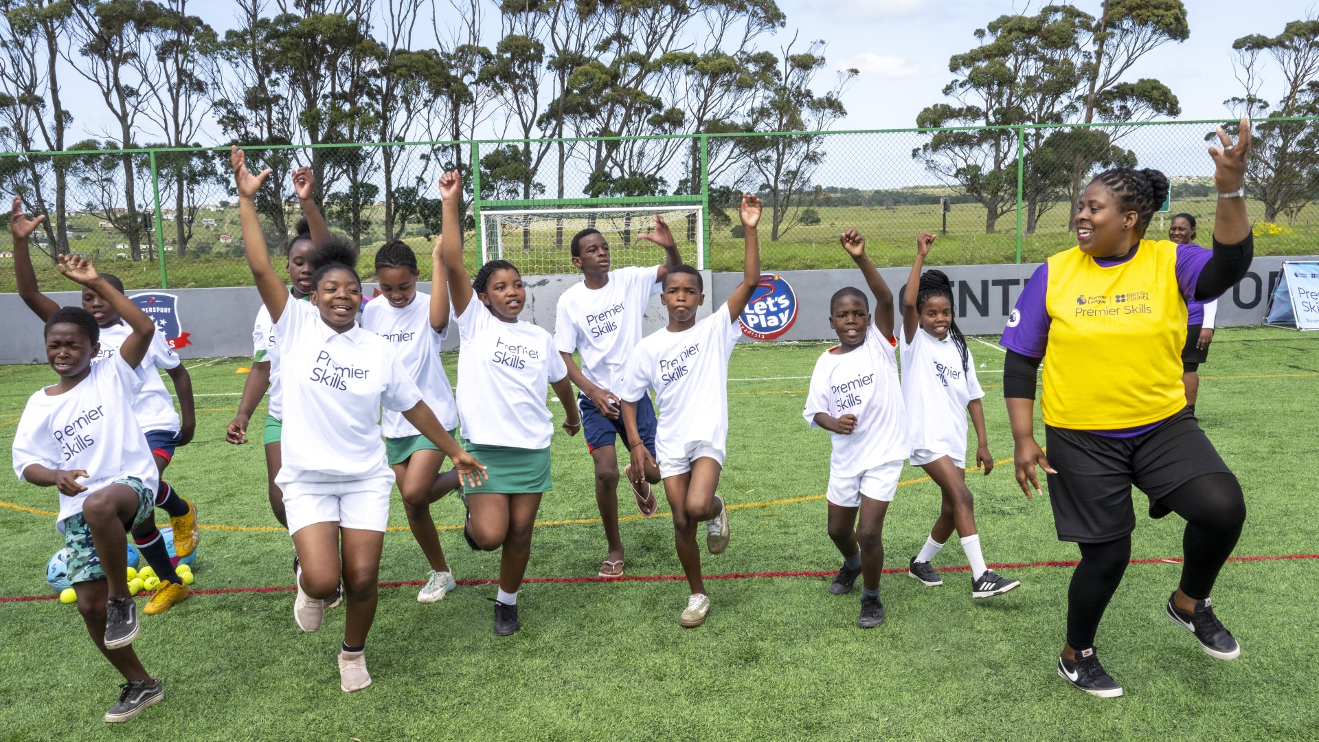 Nomnikelo Nqodi dancing with kids at a Premier Skills event