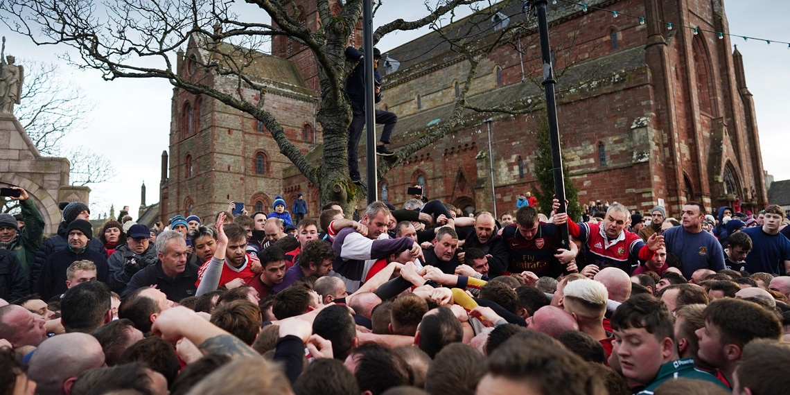 Orkadians take part in the New Year’s Ba’ Game played with a hand crafted leather ball in Kirkwall Scotland