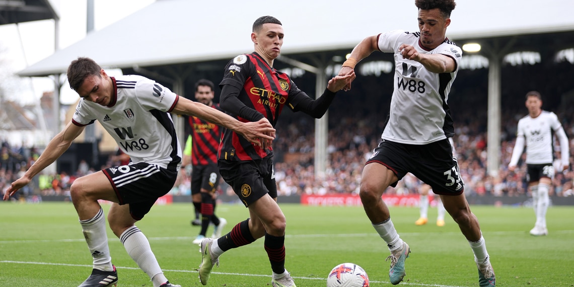 Phil Foden battles for possession with Joao Palhinha and Antonee Robinson during the match between Fulham and Manchester City