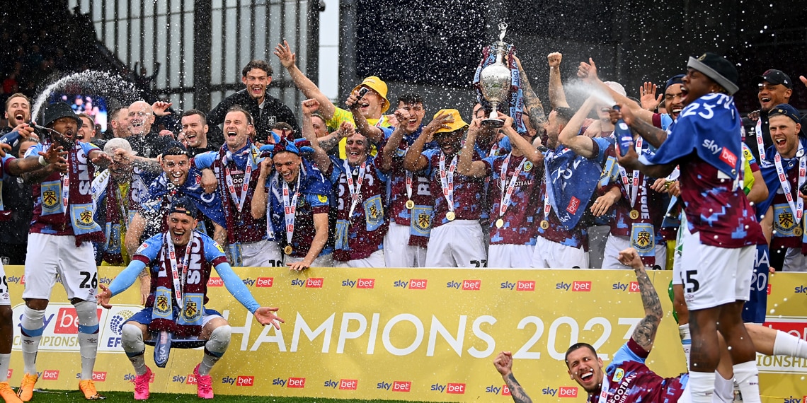 Players of Burnley celebrate with the Championship trophy as they celebrate promotion to the Premier League