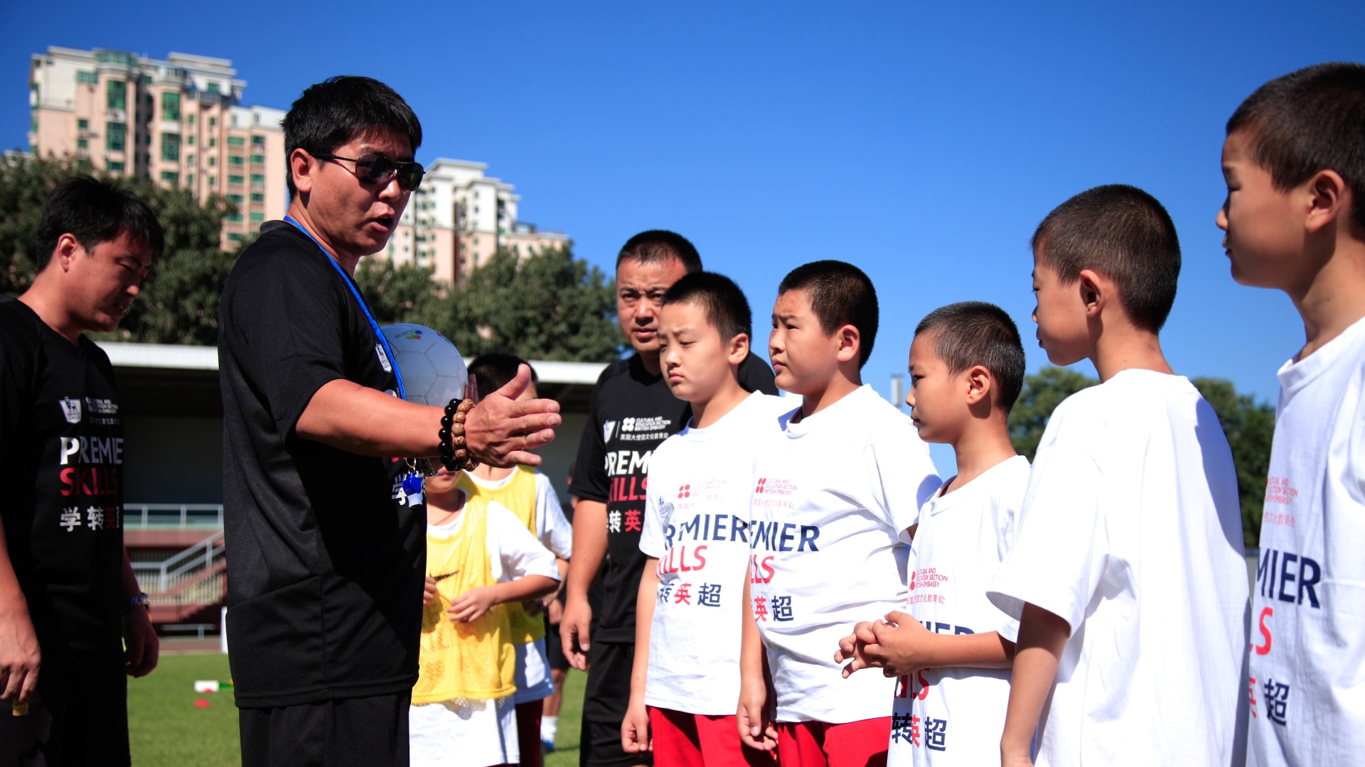 A coach talking to some children in China