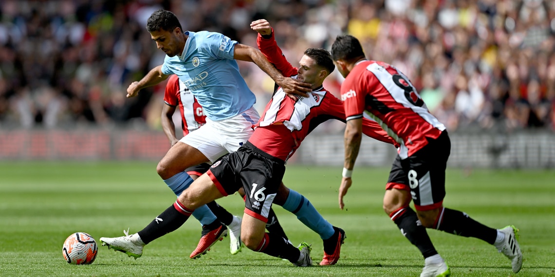 Rodri is tackled by Oliver Norwood during the match between Sheffield United and Manchester City