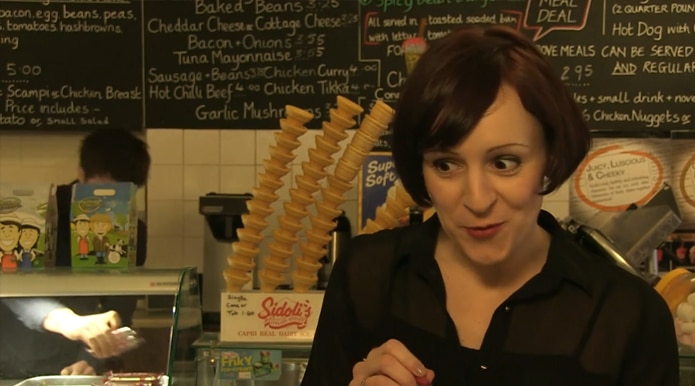 The waitress offers Claudio the 'Belly Buster'.