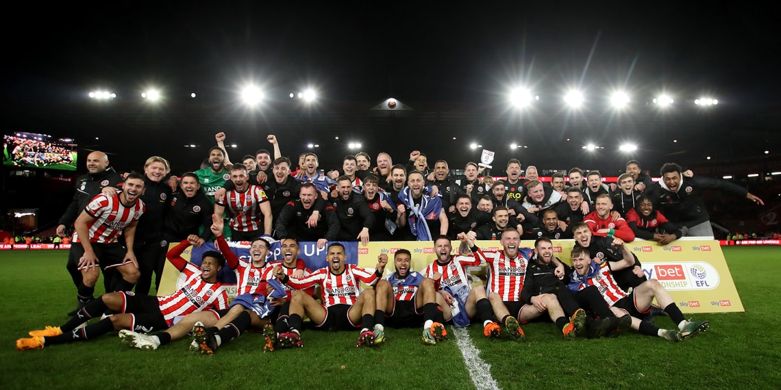 Sheffield United players and staff pose for a photo after winning promotion to the Premier League