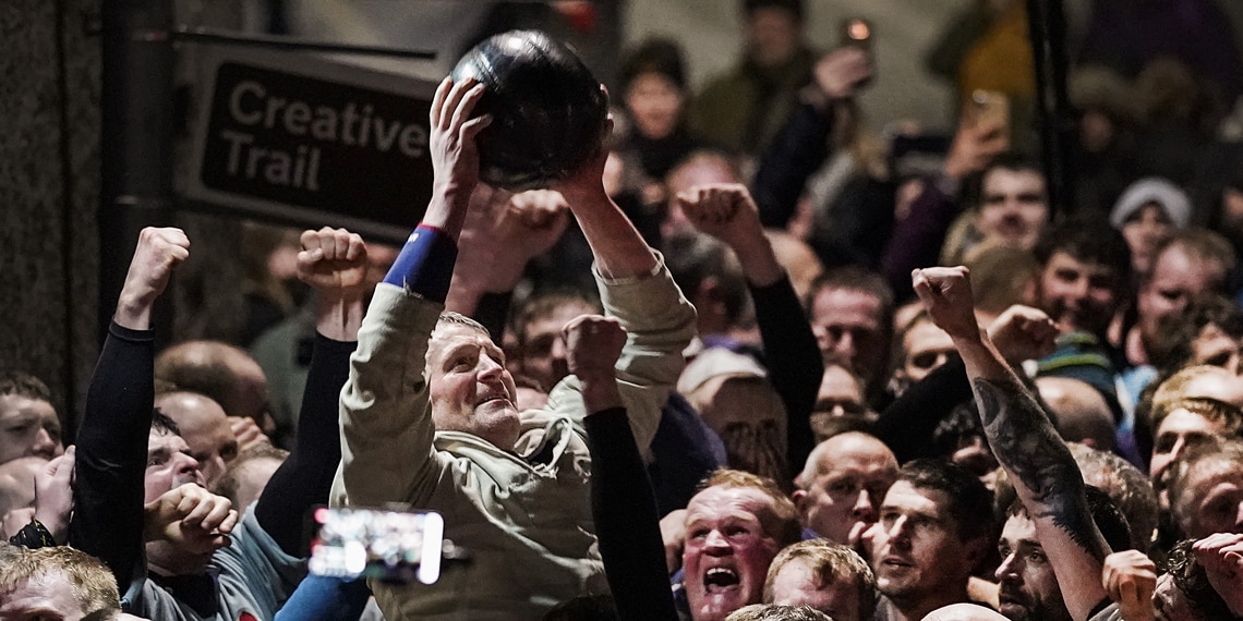 Uppies celebrate winning the New Year’s Ba’ Game played with a hand crafted leather ball in Kirkwall Scotland