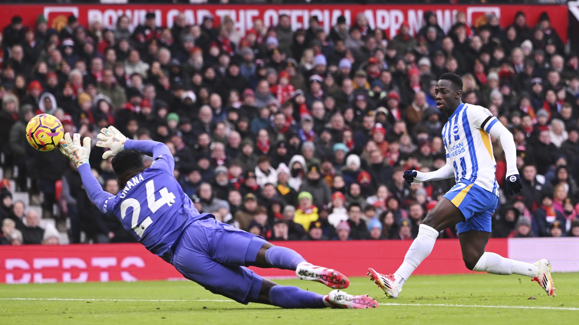 Yankuba Minteh of Brighton & Hove Albion scores his team's first goal past Andre Onana