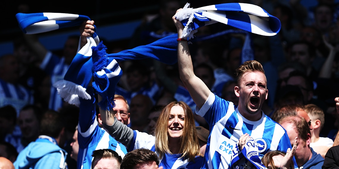 Brighton fans CHEERING ON their team.