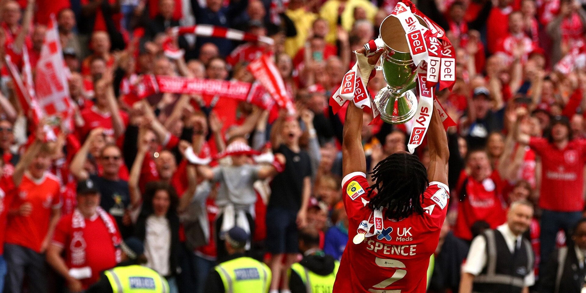 Djed Spence of Nottingham Forest lifts the trophy following their sides victory