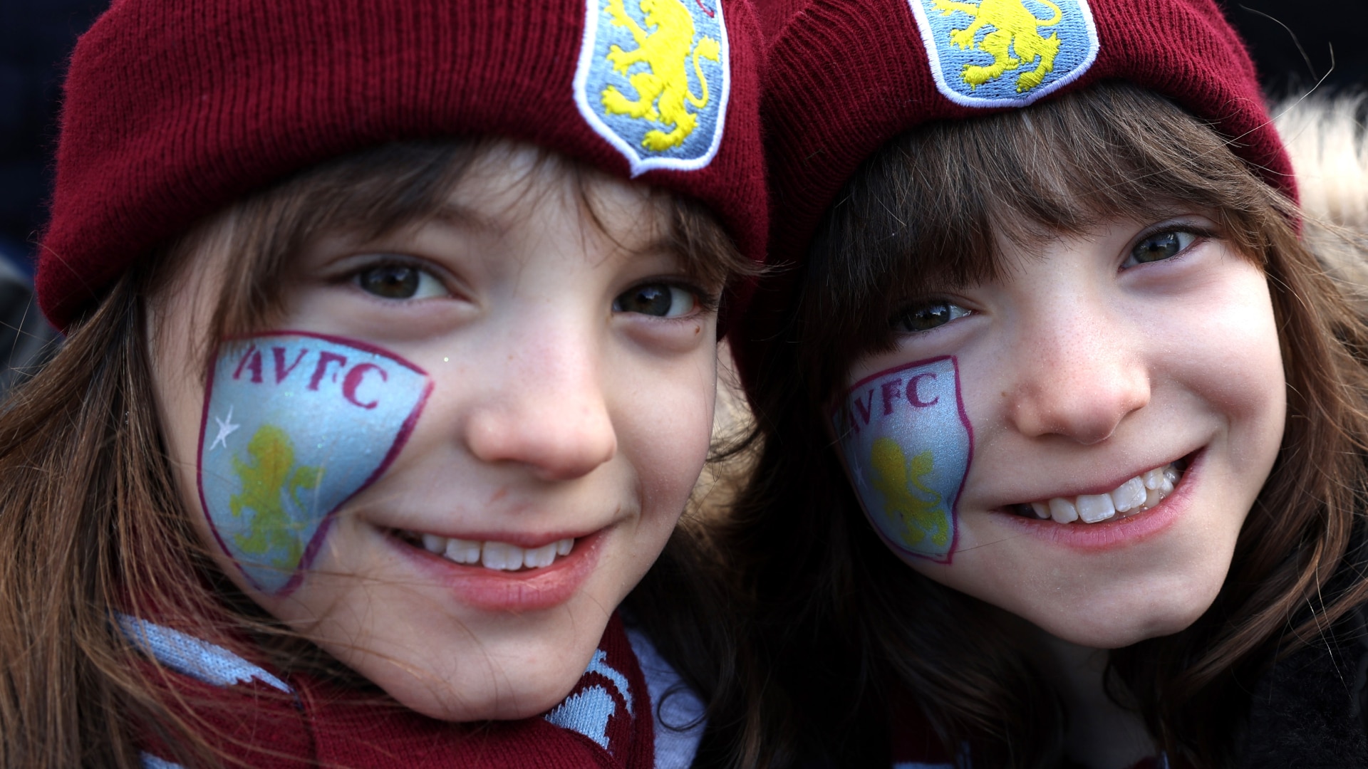 Two young Aston Villa fans with face paint