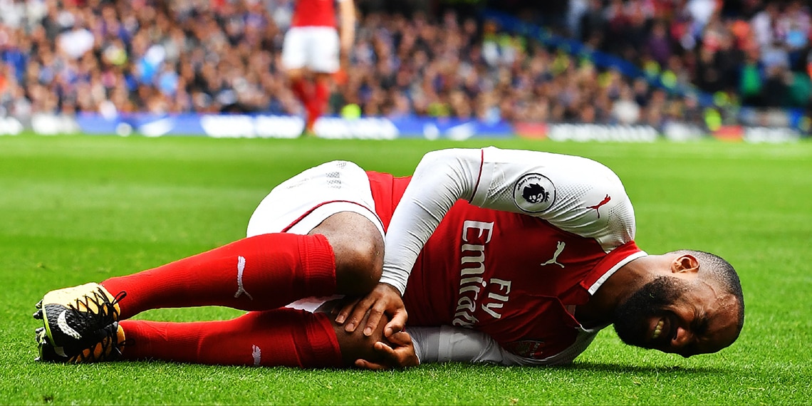 Arsenal's Alexandre Lacazette lying injured/damaged on the pitch. Which word is correct?