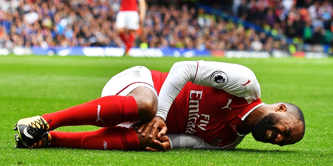 Alexandre Lacazette injures his knee during a match for Arsenal.