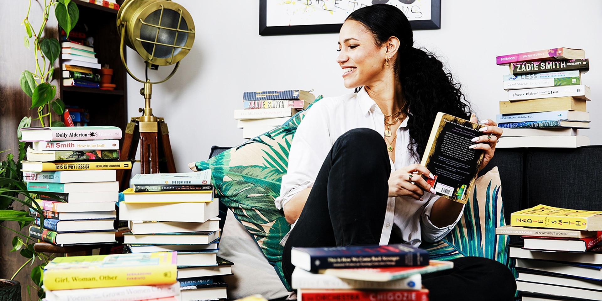 A woman in a room of books.