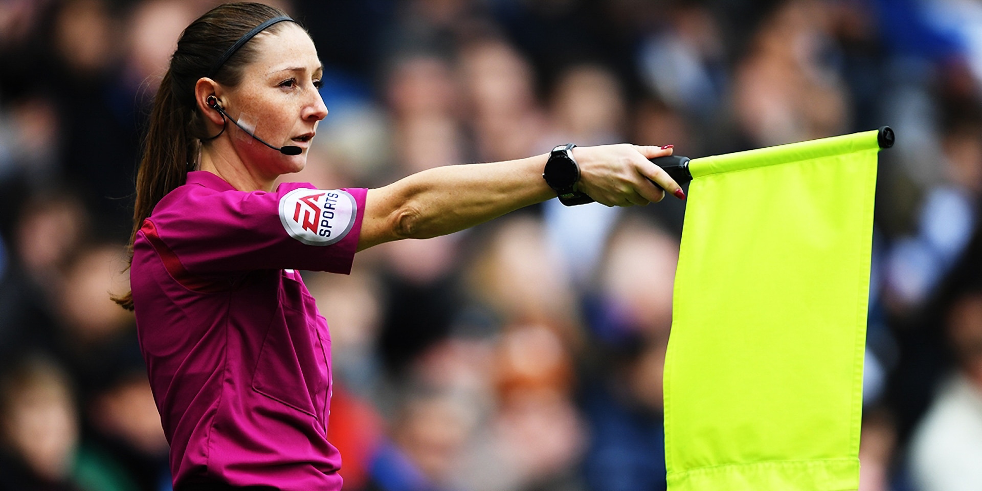 A Premier League assistant referee flagging for offside.