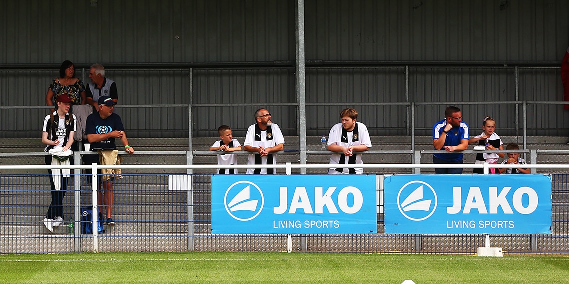 Football fans used to STAND UP at matches but these days it's more common to SIT DOWN.